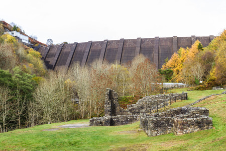 Ruins of Bryntail Lead Mine, the Clywedog Dam in the distance. Llanidloes, Powys, Wales, United Kingdom.の写真素材
