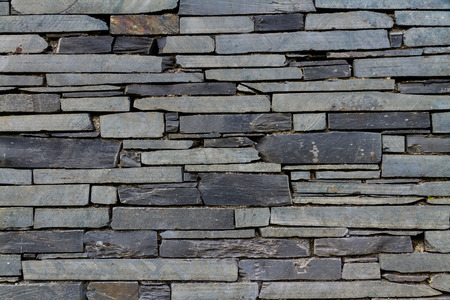 Dry stone slate wall making background textureの写真素材