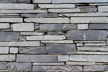 Dry stone slate wall making background textureの写真素材