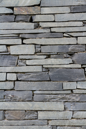 Dry stone slate wall making background textureの写真素材