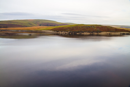 The Claerwen Reservoir part of Elan Valley Reservoirs on a still Autumn Fall morning. Powys, Wales, United Kingdom.の写真素材