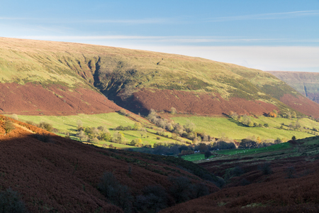 Looking down at valley, evening sunlight, autumn, fall. Gospel Pass in the Black Mountains near Hay on Wye, Powys, Wales, United Kingdom, Europe.の写真素材