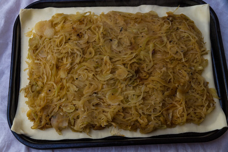 Cooked onions on puff pastry when making pissaladiereの写真素材