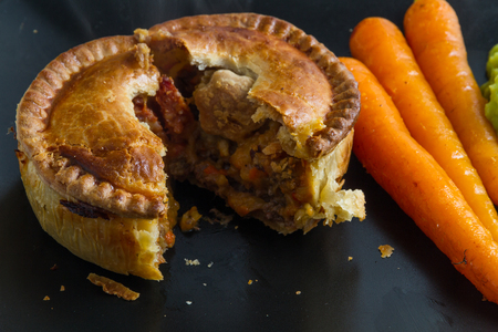 Quality chicken pie served with freshly squeezed orange glazed carrots and mushy peas.の写真素材