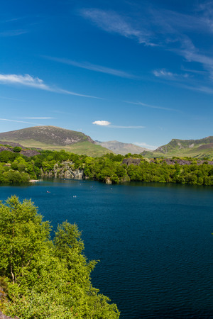 Looking across the disused Dorothea Slate Quarry to Snowdon, Nantlle, Gwynedd, Wales, United Kingdom. Flooded with water.の写真素材