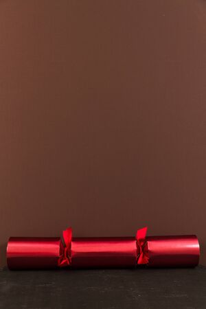 Red Christmas cracker with brown space above it.の写真素材