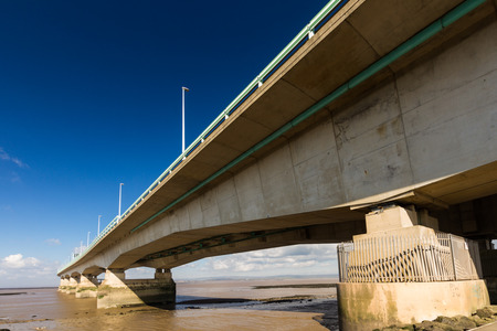 The Second Severn crossing is a bridge that carries the M4 motorway over the Bristol Channel or River Severn Estuary between England and Wales, United Kingdom. Morning light from the east.の写真素材