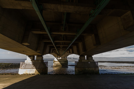 Beneath the Second Severn crossing is a bridge that carries the M4 motorway over the Bristol Channel or River Severn Estuary between England and Wales, United Kingdom. Morning light from the east.の写真素材