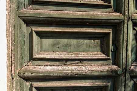 Detail of faded green door with paint peelingの写真素材