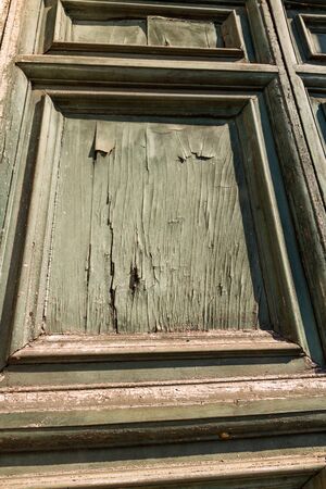 Detail of faded green door with paint peelingの写真素材