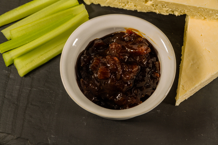 Close up of pot of red onion chutney, forming part of cheeseboard.の写真素材