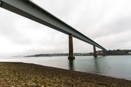 Below a metal lined bridge. Cleddau Bridge, between Neyland and Pembroke Dock, Pembrokeshire, Wales, United Kingdom.の写真素材