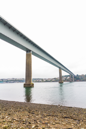 Below a metal lined bridge. Cleddau Bridge, between Neyland and Pembroke Dock, Pembrokeshire, Wales, United Kingdom.の写真素材