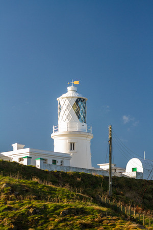 Stumble head lighthouse on a sunny day. Pencaer, Pembrokeshire, Wales, United Kingdom.の写真素材