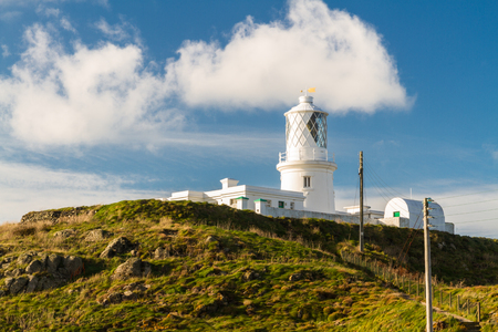 Stumble head lighthouse on a sunny day. Pencaer, Pembrokeshire, Wales, United Kingdom.の写真素材