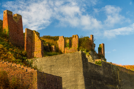 Derelict brick hoppers in Sunshine. Porthgain, Pembrokeshire, Wales, United Kingdom.の写真素材