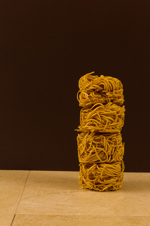 Stack of four noodle nests, copy space to left.の写真素材