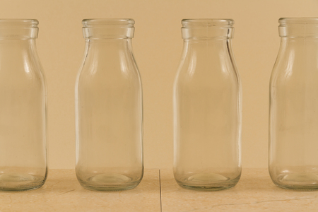 Childrenâs water drink in bottle with straw. Slices of orange, lemon and lime. Copy space on leftの写真素材