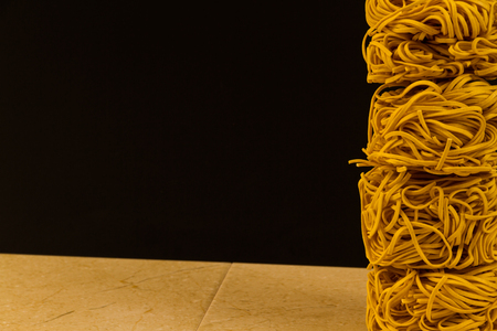Stack of four noodle nests, copy space to left.の写真素材