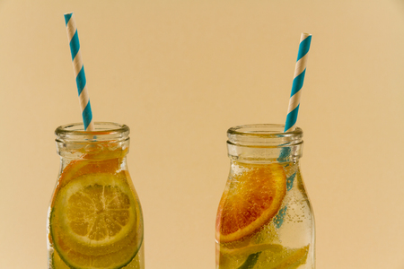 Childrenâs sparkling water drinks in bottles with straw. Slices of orange, lemon and lime.の写真素材