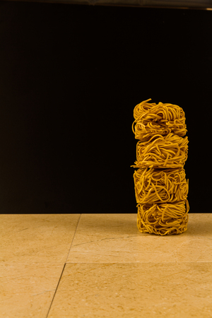 Stack of four noodle nests, copy space to left.の写真素材