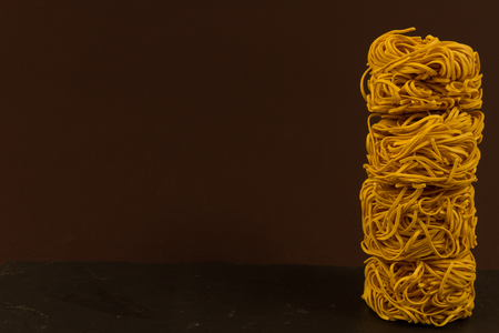 Stack of four noodle nests, copy space to left.の写真素材