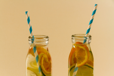 Childrenâs water drinks in bottles with straw. Slices of orange, lemon and lime.の写真素材
