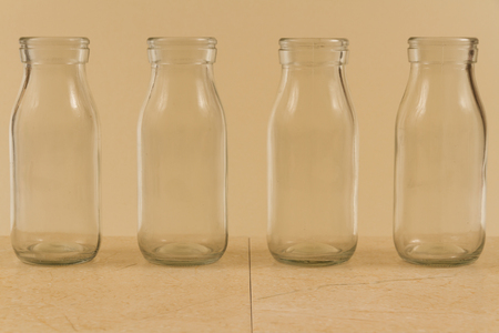 Childrenâs water drink in bottle with straw. Slices of orange, lemon and lime. Copy space on leftの写真素材