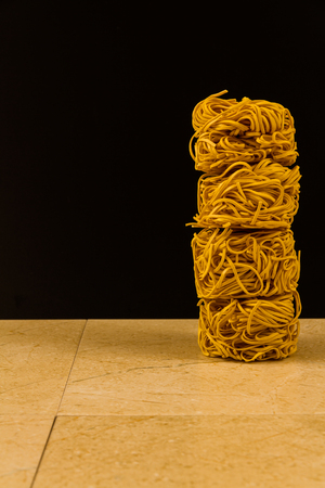 Stack of four noodle nests, copy space to left.の写真素材