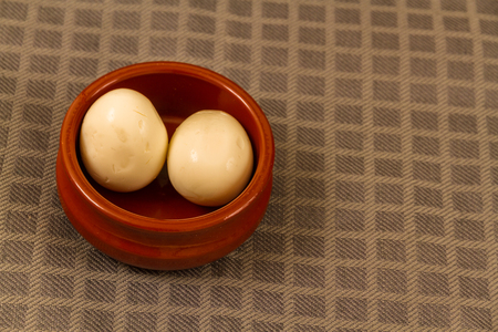 Two pickled eggs in ceramic bowlの写真素材