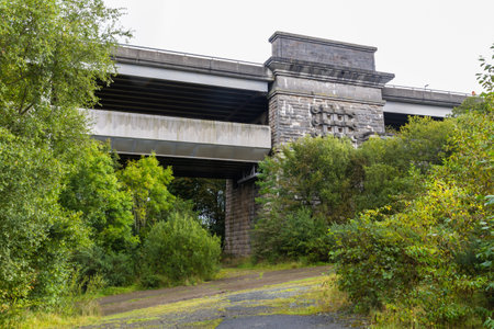 Looking up through trees at the Britannia Bridge, over the menai Strait between Gwynedd and Anglesey. North Wales, United Kingdomのeditorial素材