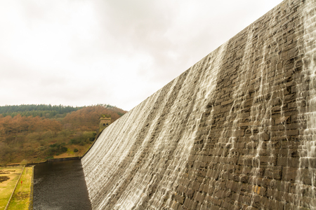 Water cascades down the Derwent Dam, Ladybower reservoir. Near Sheffield, in Peak District, Derbyshire, England, United Kingdom.の写真素材