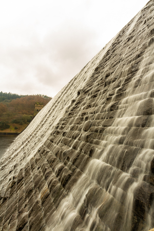 Water cascades down the Derwent Dam, Ladybower reservoir. Near Sheffield, in Peak District, Derbyshire, England, United Kingdom.の写真素材
