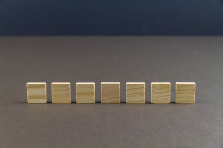 Seven wood blocks against dark background, graphic resource, template, landscapeの写真素材