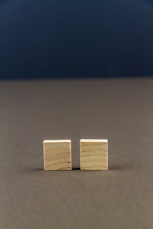 Two wood blocks against dark background, graphic resource, template, portraitの写真素材