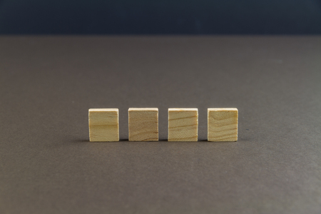 Four wood blocks against dark background, graphic resource, template, landscapeの写真素材