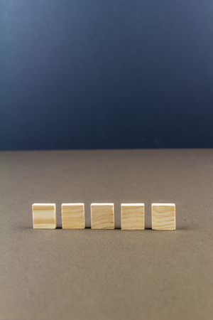 Five wood blocks against dark background, graphic resource, template, portraitの写真素材