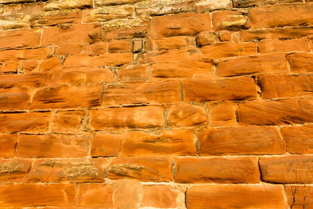 Background, sandstone brick wall lit by setting sun, Chester city wallsの写真素材