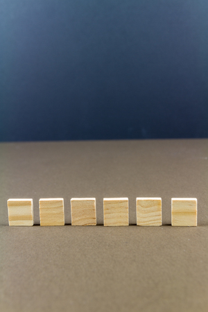Six wood blocks against dark background, graphic resource, template, portraitの写真素材