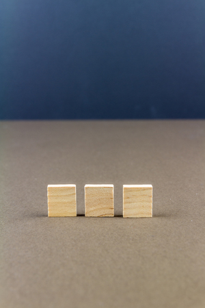 Three wood blocks against dark background, graphic resource, template, portraitの写真素材