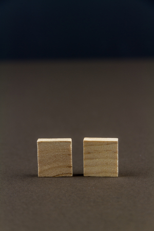 Two wood blocks against dark background, graphic resource, template, portrait, macroの写真素材