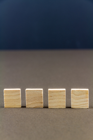 Four wood blocks against dark background, graphic resource, template, portrait, macroの写真素材