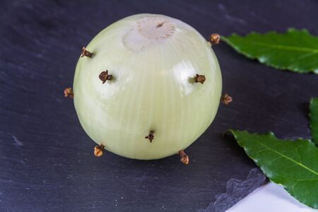 Dry Ingredients for bread sauce onion studded with cloves bay leaves and peppercorns, close upの写真素材