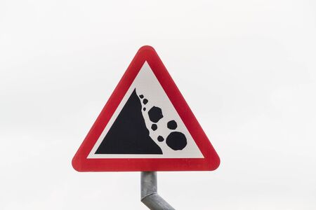 Triangular UK warning or hazard sign for Falling or fallen rocks, landscape.の写真素材
