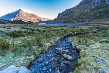 Early morning Carnedd Llewelyn, from stream and lake or Llyn Idwal.  Snowdonia national Park, Gwynedd, Wales, UK. landscape.の写真素材