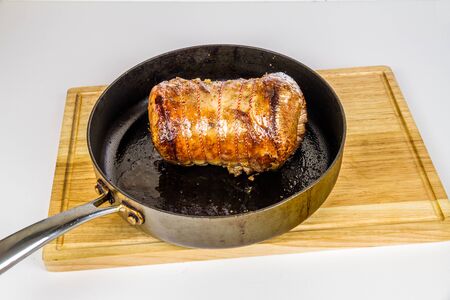 On a gas hob browning a rolled beef brisket joint, copyspace.の写真素材