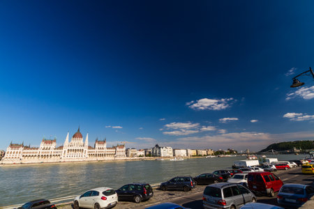 Budapest, The Hungarian Parliament Building from across the river Danube, vehicles and road in foreground â  on July 5 2019 in Hungary.のeditorial素材