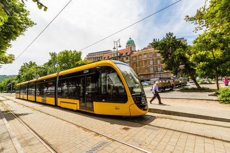 Budapest, Modern Budapest Tram  with dome of Buda Castle in the backgroundâ  on July  4 2019 in Hungary wide angle.のeditorial素材