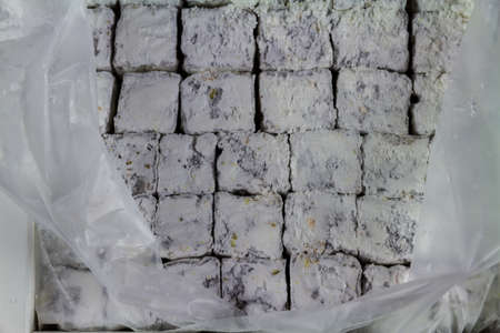 Turkish delight in a grid with packaging making a background or texture.