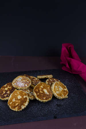 Welsh cakes on a slate platter scattered with sugar, landscape copyspace at top and portrait.の写真素材